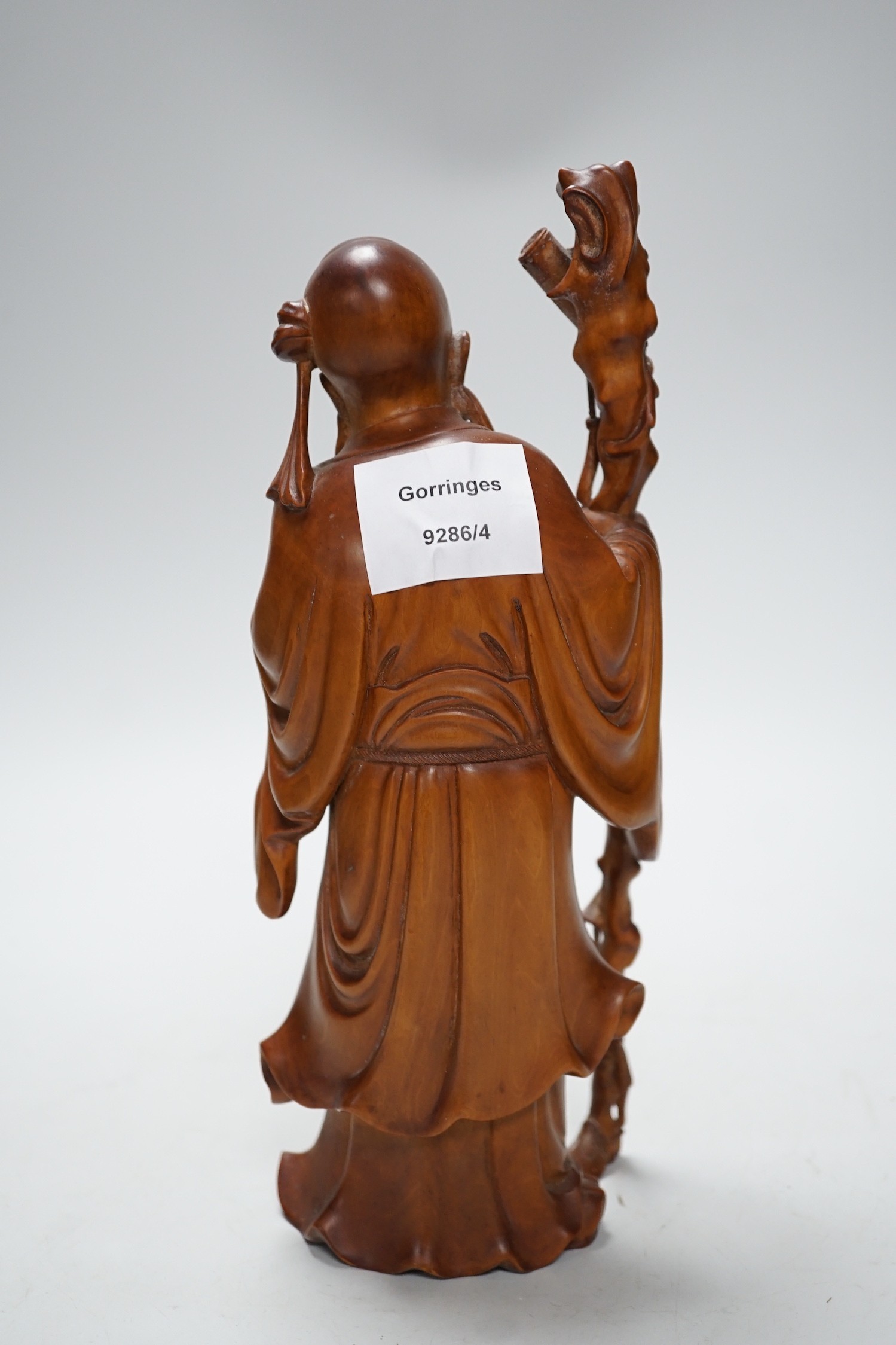 An early 20th century Chinese carved boxwood figure of Shou Lao, 26cm
